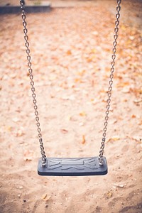 Black plastic swing in a playground