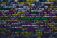 Software developer programming code on black background
