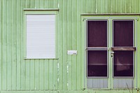 Green building with a window shutter