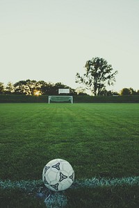 View of soccer field with a ball on the sideline