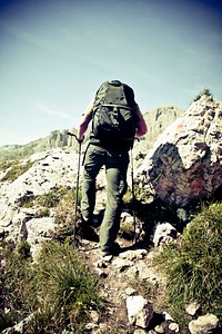 Backpacker trekking with poles in South Tyrol