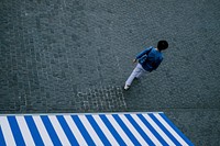 Aerial view of a man walking down a square