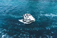 Snow covered rock in the ocean
