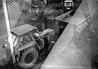 Grayscale image of a tractor with a dump cart attached