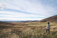 Woman looking across the meadows