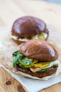 Close up of two thick hamburgers on a wooden table