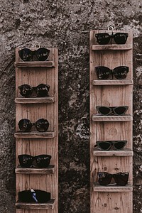 A wooden rack with sunglasses