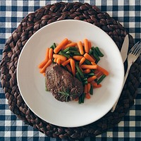 A beef steak with vegetables