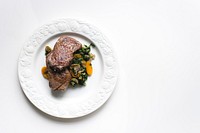 A beef steak and vegetables