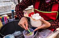 A vendor serving fresh coconut ice cream