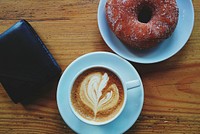 Cup of cappuccino with a donut