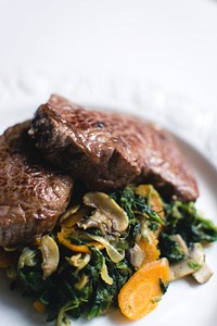 A beef steak and vegetables