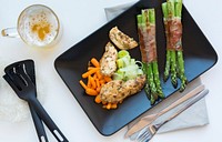 Chicken breast with bacon-wrapped asparagus  and a glass of beer