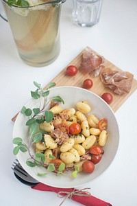 Gnocchi with prosciutto crudo and cherry tomatoes food photography