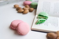 Pink and green macaroons and a book on the table