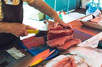 Seller slicing a fish fillet