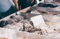 Fishmonger selling fish at a fish market