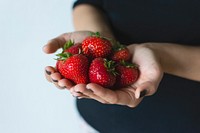 Woman carrying fresh strawberries