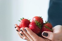Woman carrying fresh strawberries