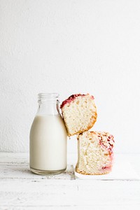 Bottle of milk and yeast cake topped with strawberries. Visit <a href="https://monikagrabkowska.com/" target="_blank">Monika Grabkowska</a> to see more of her food photography.