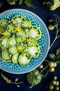 Plate of fresh green tomato salad. Visit <a href="https://monikagrabkowska.com/" target="_blank">Monika Grabkowska</a> to see more of her food photography.