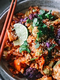 Kimchi fried rice with cilantro, sesame seeds, black pepper, and lime juice