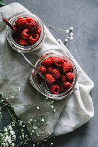 Fresh raspberry in jars