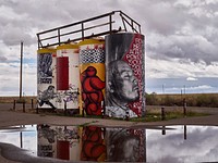 Artwork on water towers along a remote Arizona road leading to Monument Valley Navajo Tribal Park, a red-sand desert region on the Arizona-Utah border known for the towering sandstone buttes.