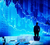 Silhouette of a businessman looking at stocks