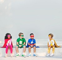 Superhero kids sitting together outdoors