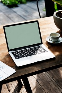 Laptop with an empty screen on a wooden table