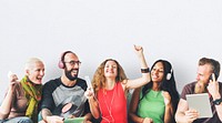 Happy group of friends sharing and listening to music