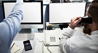 Corporate men working in an office and empty computer screens