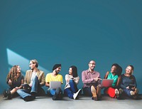 Group of diverse people in a row sitting on the floor