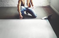 Man planning on a big sheet of empty paper