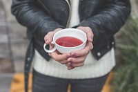 Free woman hands holding pink herbal tea cup photo, public domain beverage CC0 image.