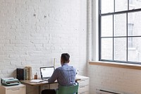 Free man working on laptop at desk image, public domain CC0 photo.