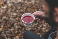 Free man holding herbal tea cup photo, public domain beverage CC0 image.