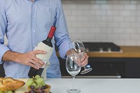 Free man pouring a glass of red wine image, public domain drink CC0 photo.