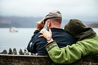 Free couple sitting on a bench looking out over the water image, public domain CC0 photo.