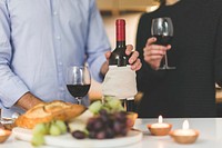 Free man and woman drinking wine with appetizer on kitchen counter image, public domain drink CC0 photo.