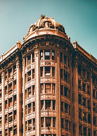 A corner view of a large old building with ornate architecture.