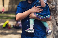 Father carrying daughter in a park, free public domain CC0 image.