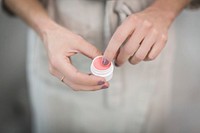 Free woman putting lip balm from the container public domain CC0 photo.