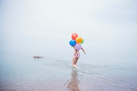 Woman carrying latex balloon in sea image, free public domain decoration CC0 photo.