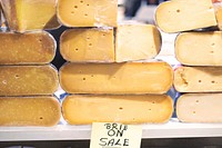 Free stacked half wheels of brie cheese at a farmers market, public domain fruit CC0 photo.