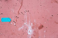Faded red cement texture with spots of paint and blue tape, free public domain CC0 image.