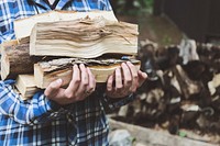 Free person carrying a stack of chopped wood photo, public domain CC0 image.