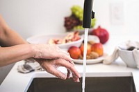 Free woman lathers soap in her hands in the kitchen sink, public domain people CC0 photo.