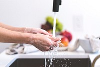 Free hands lathering soap and washing hands in the kitchen sink, public domain people CC0 photo.